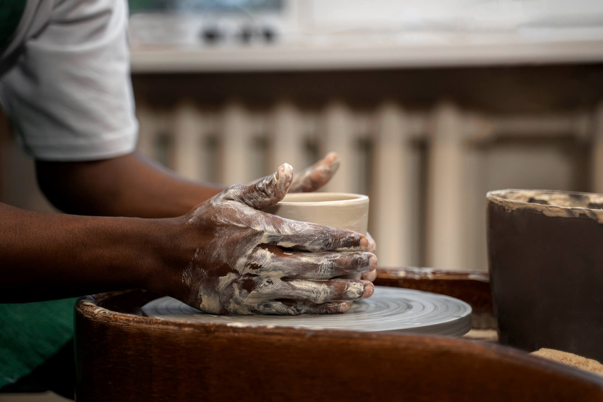 hands-making-bowl-side-view